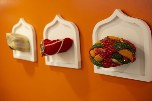 Culturally inspired office wall display showcasing traditional Indian textiles in a branded workspace
